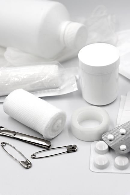 Dental first aid kit contents spread on a table in a remote setting